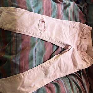 It has one hole. It’s a nice color pink.  they actually have pockets